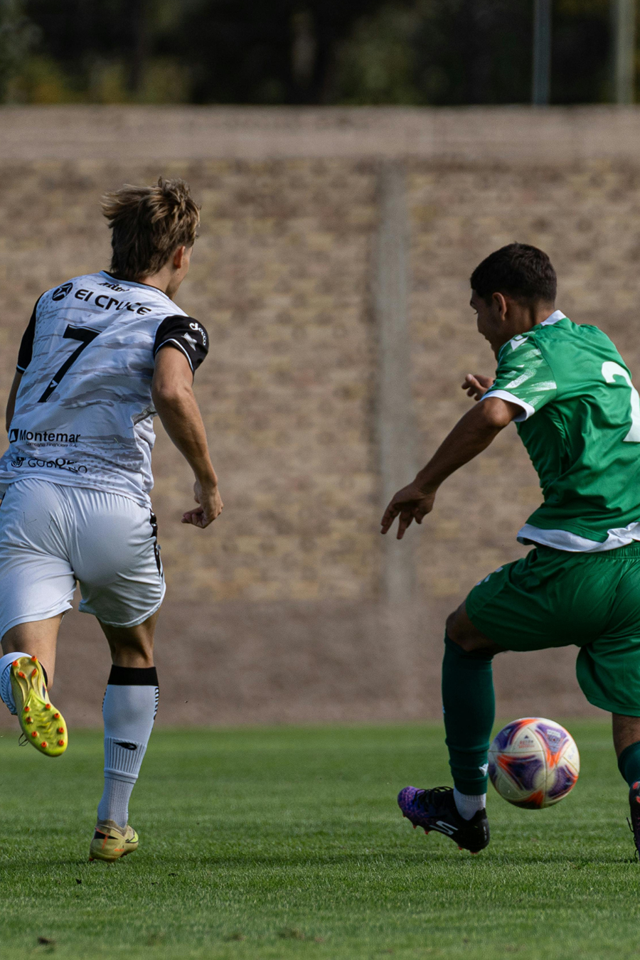 two people playing soccer