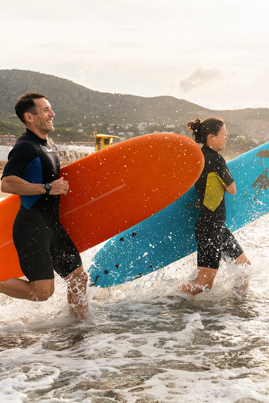 two people with surfboards