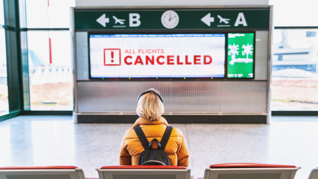 woman waiting at airport flights cancelled