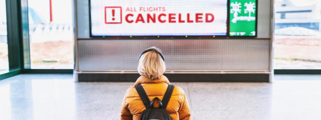 woman waiting at airport flights cancelled