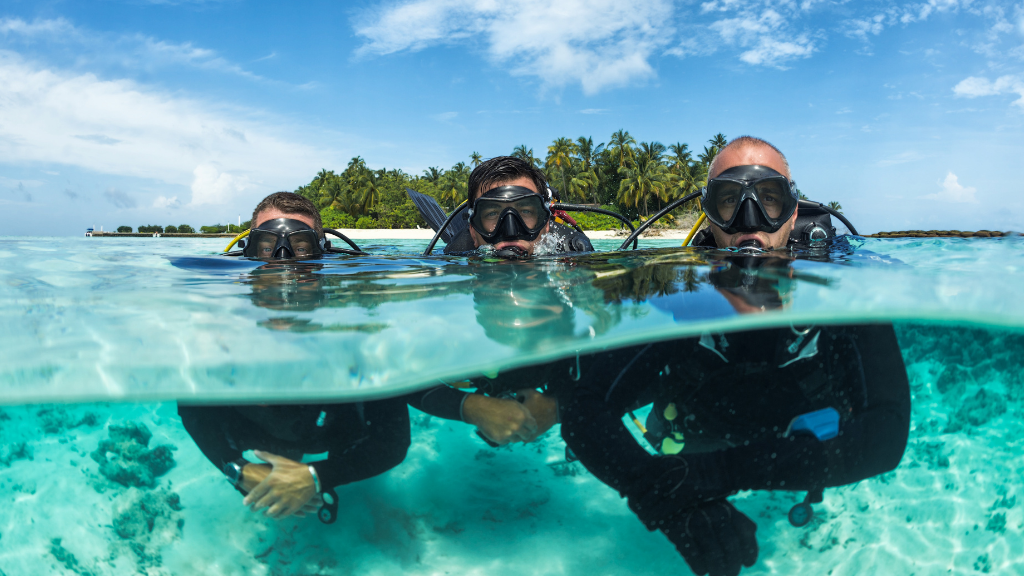 three people scuba diving