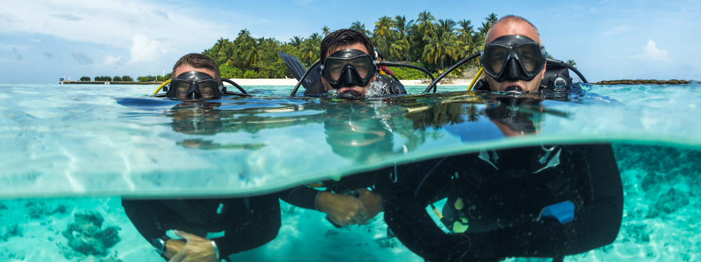 three people scuba diving